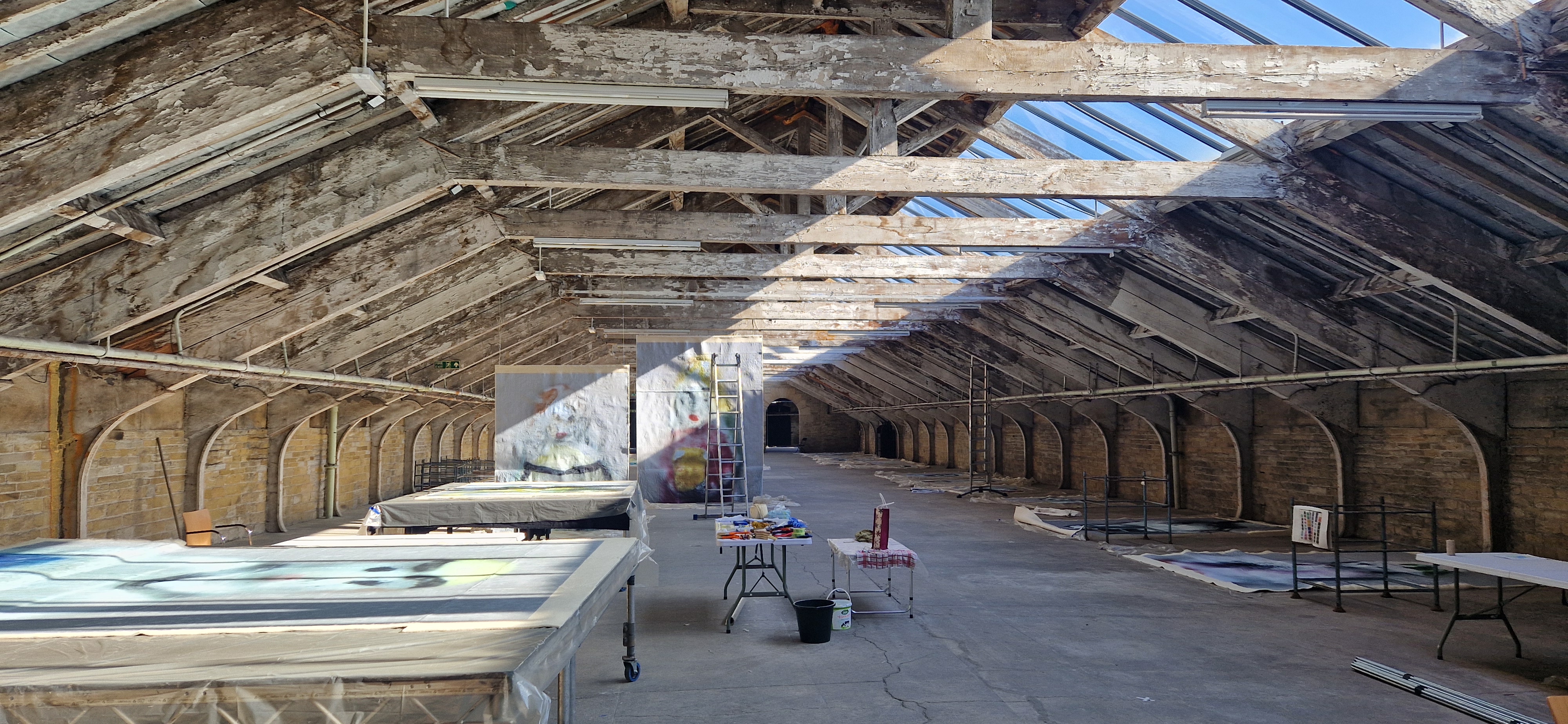 We Will Sing — venue space being prepared, banners being painted on the floor, BD25 2025