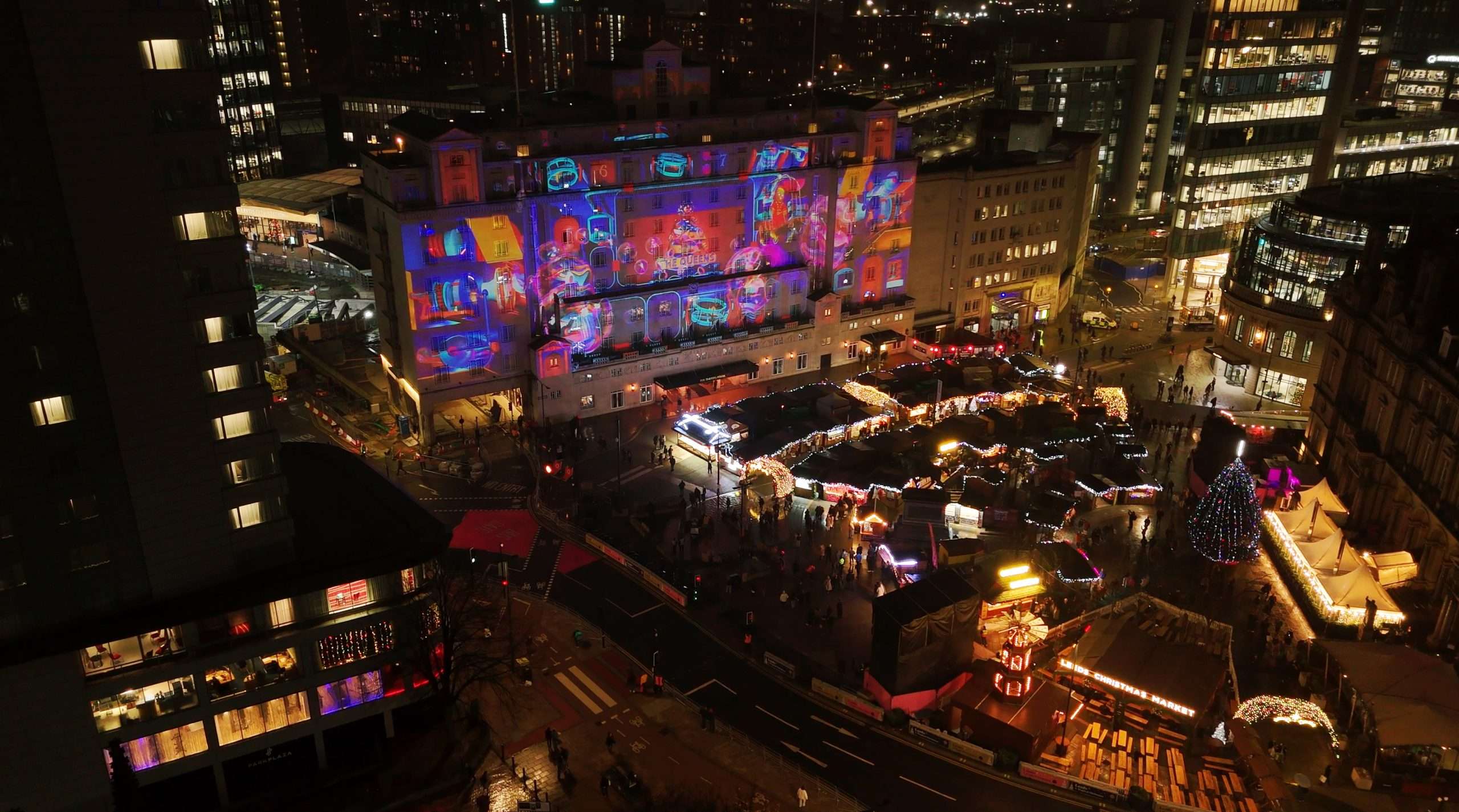 Queens Hotel Leeds — aerial view of Christmas projection mapping event, building fully illuminated by OnionLab, 2023