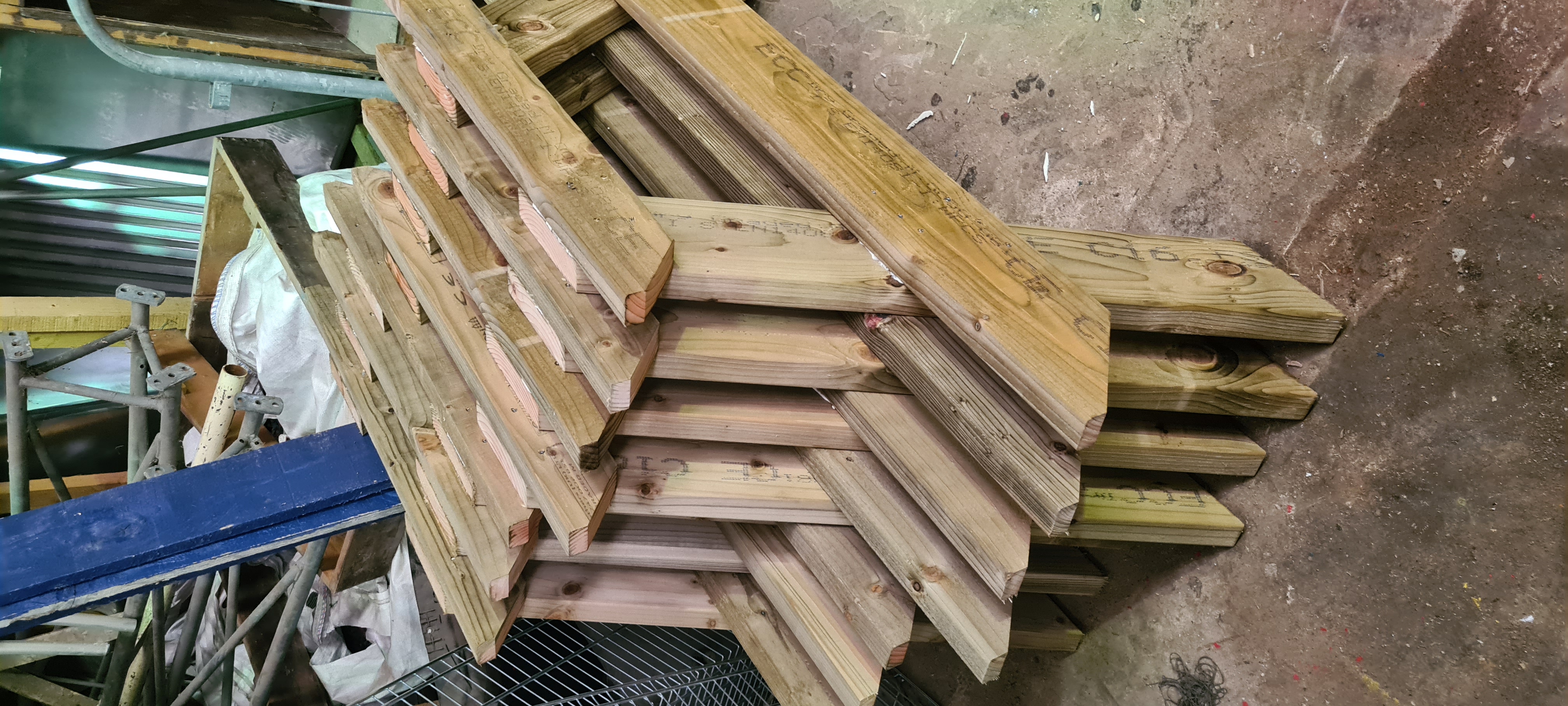 Summer Garden — completed picnic benches stacked in workshop, ready for delivery